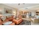 Open floorplan with a large living room including a leather couch and large mirror at 1945 Gulf Of Mexico Dr # M2-516, Longboat Key, FL 34228
