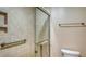 Contemporary bathroom with tile surround glass door shower and shelving at 1945 Gulf Of Mexico Dr # M2-516, Longboat Key, FL 34228