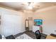 This functional and stylish room is designed with a closet, media center, and dark floors at 19962 Benissimo Dr, Venice, FL 34293