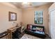 Well-lit, functional room with a desk area and futon, offering versatile living space at 19962 Benissimo Dr, Venice, FL 34293