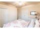 Cozy bedroom with a ceiling fan and a colorful bedspread, creating a relaxing and inviting space at 19962 Benissimo Dr, Venice, FL 34293