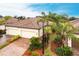 Beautiful home exterior with lush landscaping, a paved driveway, and a two-car garage at 19962 Benissimo Dr, Venice, FL 34293