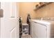 This well-organized laundry room features a modern washer, dryer, and ample storage at 19962 Benissimo Dr, Venice, FL 34293