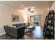Spacious living room with modern decor, comfortable seating, and a sliding glass door at 19962 Benissimo Dr, Venice, FL 34293
