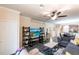 Inviting living room featuring a ceiling fan, modern shelving, and a view of the dining area at 19962 Benissimo Dr, Venice, FL 34293