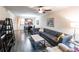 An open-concept living room featuring neutral walls, modern furniture, and wood floors at 19962 Benissimo Dr, Venice, FL 34293