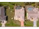 Aerial view of property showcasing roof, backyard pools, landscaping, and driveway at 215 Santarem Cir, Punta Gorda, FL 33983