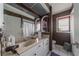 Bathroom featuring a vanity, mirror, toilet, shower, and window at 215 Santarem Cir, Punta Gorda, FL 33983