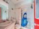 Bathroom with a sink, toilet, shower, and blue and white walls at 215 Santarem Cir, Punta Gorda, FL 33983