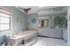 Relaxing bathroom features double sinks, a large soaking tub, neutral walls, and nautical themed décor at 215 Santarem Cir, Punta Gorda, FL 33983