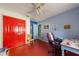 Bedroom with blue walls, a ceiling fan, red trim, and a closet at 215 Santarem Cir, Punta Gorda, FL 33983