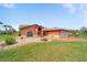 Charming single-story home featuring a well-manicured lawn and colorful landscaping at 215 Santarem Cir, Punta Gorda, FL 33983
