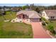 Aerial view of well maintained home with colorful landscaping and an attached two-car garage at 215 Santarem Cir, Punta Gorda, FL 33983