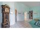 Hallway view with a grandfather clock and a white tile floor at 215 Santarem Cir, Punta Gorda, FL 33983