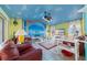 Cozy living room with colorful walls, a ceiling fan, and comfortable seating at 215 Santarem Cir, Punta Gorda, FL 33983