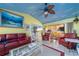 Spacious living room with colorful walls, tile floors, and sliding glass doors leading to the outdoors at 215 Santarem Cir, Punta Gorda, FL 33983