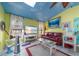 Bright living room with colorful accents, tile flooring, modern furniture, and ample natural light at 215 Santarem Cir, Punta Gorda, FL 33983
