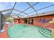 Enclosed pool area with outdoor seating, a built-in fountain, and access to the sunroom at 215 Santarem Cir, Punta Gorda, FL 33983