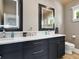 Bathroom featuring dual sinks with light-up mirrors, wood ceilings, and a tile floor at 217 Spring Ave, Anna Maria, FL 34216