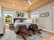 Main bedroom featuring a wood ceiling, tile floors, windows, and two leather chairs at 217 Spring Ave, Anna Maria, FL 34216