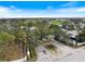 Community entrance showcasing landscaping, a roundabout, and golf course views at 28 Dominica Dr, Englewood, FL 34223