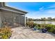 Backyard patio with potted plants and a view of the screened-in porch at 28 Dominica Dr, Englewood, FL 34223