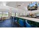 Modern clubhouse bar boasts seating, a television, and scenic views at 28 Dominica Dr, Englewood, FL 34223