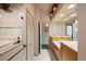 Well-lit bathroom showcasing a tiled shower, double vanity, and neutral color scheme at 28 Dominica Dr, Englewood, FL 34223