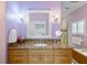 Beautiful bathroom with a granite vanity, framed mirror, sconces and a tub at 28 Dominica Dr, Englewood, FL 34223
