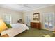 Bedroom with shuttered windows, dresser with a mirror and a ceiling fan at 28 Dominica Dr, Englewood, FL 34223