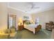 Spacious bedroom features a ceiling fan, shuttered windows, and neutral decor at 28 Dominica Dr, Englewood, FL 34223