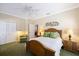 Bright bedroom featuring a ceiling fan, wood furniture, and coastal decor on the wall at 28 Dominica Dr, Englewood, FL 34223