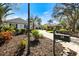 Charming home entrance with a brick driveway and lush tropical landscaping at 28 Dominica Dr, Englewood, FL 34223