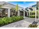 Inviting entrance to the community clubhouse with lush landscaping and a covered walkway at 28 Dominica Dr, Englewood, FL 34223