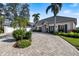 Charming home with a circular driveway and a three-car garage at 28 Dominica Dr, Englewood, FL 34223