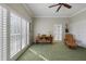 Sunlit home office space featuring large windows, a wooden desk, and a leather recliner at 28 Dominica Dr, Englewood, FL 34223