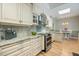 Gourmet kitchen with stone countertops, custom cabinets, and modern appliances at 28 Dominica Dr, Englewood, FL 34223