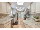 Expansive kitchen features granite countertops, custom cabinetry, and stainless steel appliances at 28 Dominica Dr, Englewood, FL 34223