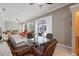 Open concept lanai offering serene water views, comfortable seating, and seamless indoor/outdoor flow at 28 Dominica Dr, Englewood, FL 34223