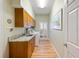 Bright laundry room featuring built in cabinets, sink, washer, dryer and lots of natural light at 28 Dominica Dr, Englewood, FL 34223
