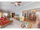 Open-concept living room with tile flooring, ceiling fan, and a view of the dining room at 28 Dominica Dr, Englewood, FL 34223