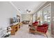 Comfortable living room with tile floors, ceiling fan, and sliding glass doors to a view of the pool at 28 Dominica Dr, Englewood, FL 34223