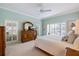 Light and bright main bedroom with a ceiling fan, shuttered windows and a dresser with mirror at 28 Dominica Dr, Englewood, FL 34223