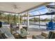 Covered outdoor seating area with comfortable seating and a screened-in pool at 28 Dominica Dr, Englewood, FL 34223
