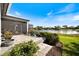 A peaceful screened-in lanai with a paver patio overlooks a serene lake at 28 Dominica Dr, Englewood, FL 34223