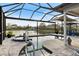 Relaxing screened-in pool with a spa and waterfront views at 28 Dominica Dr, Englewood, FL 34223