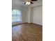 A spacious bedroom with a ceiling fan and large window allowing natural light at 3722 S Cranberry Blvd, North Port, FL 34286