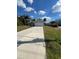 Single-story home with a long driveway, two car garage, and arched front entryway at 3722 S Cranberry Blvd, North Port, FL 34286