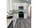 Well-lit kitchen featuring gray countertops, white cabinetry, and stainless steel appliances at 3722 S Cranberry Blvd, North Port, FL 34286