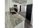 A modern kitchen features stainless steel appliances, granite countertops, and white cabinets at 3722 S Cranberry Blvd, North Port, FL 34286